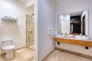 A bathroom with a toilet, shower, and two sinks with a large mirror. - Coastal Sayulita Sanctuary - stunning 3 bed ocean view condo a block from beach (Sayulita)