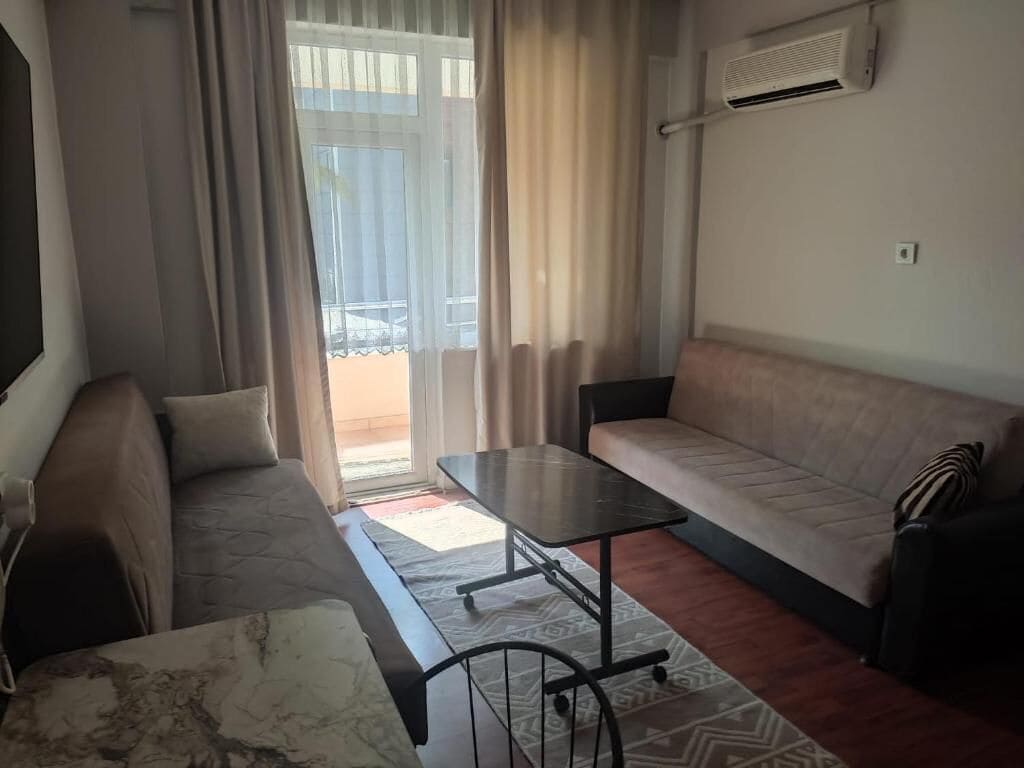 Apartment, Garden View | Living area | 43-inch LCD TV with satellite channels
