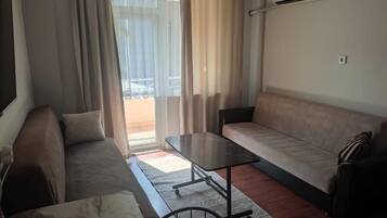 Apartment, Garden View | Living area | 43-inch LCD TV with satellite channels