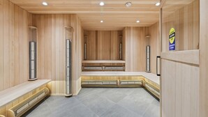 A sauna room with wooden walls, benches, and benches with heating elements.