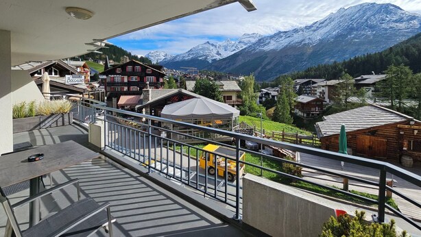 A balcony with a view of a mountain village, including buildings and snow-capped peaks. - Nicoletta 2. OG Appartement/Fewo 8-Bettwohnung Nr. 1 by Interhome (Saas-Fee)