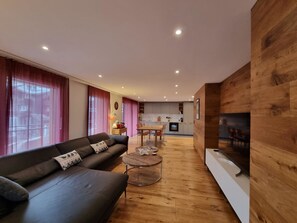 A modern living room with a sofa, coffee table, and wooden accents. - Gletschergarten Appartement/Fewo 6-Bettwohnung by Interhome (Saas-Fee)
