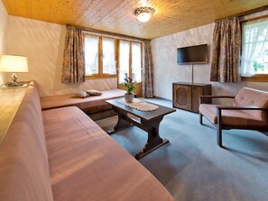 A cozy living room with a sofa, a coffee table, a TV, and a cabinet. - Maria Appartement/Fewo 4-Bettwohnung Nr. 5 by Interhome (Saas-Fee)