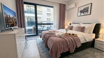 Premium Apartment, Courtyard View | In-room safe, laptop workspace, blackout curtains, iron/ironing board