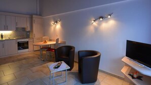 A modern living space with a kitchen, dining area, and entertainment unit. - Mischi Appartement/Fewo 2-Bettwohnung Nr. 15 by Interhome (Saas-Fee)