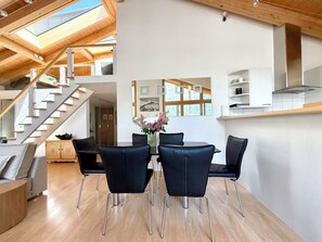 A modern interior with a dining area, wooden staircase, and skylights. - Penthouse Victoria’s Home im Haus Judith Appartement/Fewo Appartement/Fewo by Interhome (Saas-Fee)