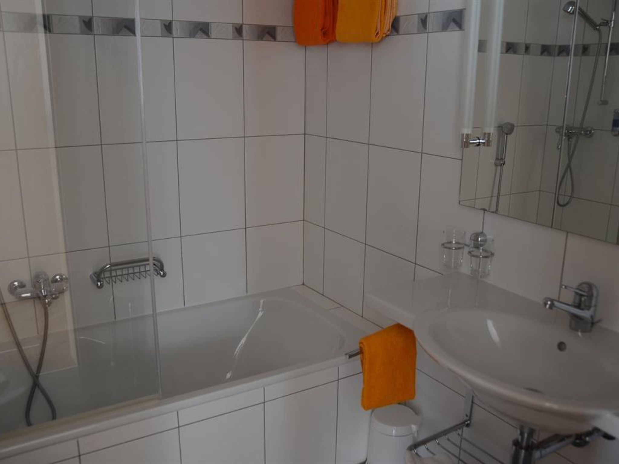 A bathroom with a bathtub, a sink, and a shower.