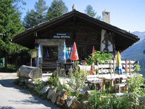 A restaurant named 'Restaurant Alp-Hitta' with outdoor seating and a mountain backdrop. - Chalet Antika Appartement/Fewo 5-Bettwohnung by Interhome (Saas-Fee)