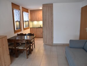 A compact living space with a dining area, kitchenette, and a sofa. - Topas Appartement/Fewo 4-Bettwohnung Nr. 13 by Interhome (Saas-Fee)