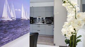 A modern kitchen with grey cabinets, a marble countertop, and a white orchid vase. - Mine Hygge by Interhome (Koserow)