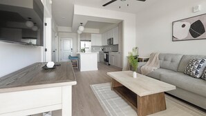 Een moderne keuken met witte kasten, een centraal eiland en een eethoek met een houten tafel.