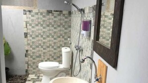 A bathroom with a wooden vanity, a large basin, a toilet, and a shower. - Abrisam Shareeah Family Homestay (Yogyakarta)