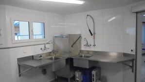 A modern kitchen with stainless steel appliances, a window, and a sink. - Weideli Appartement/Fewo 6 Bettwohnung Nr. 21 by Interhome (Saas-Grund)