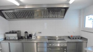 A stainless steel kitchen with a gas stove, oven, and coffee maker. - Weideli Appartement/Fewo 6 Bettwohnung Nr. 21 by Interhome (Saas-Grund)
