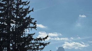 Eine Berglandschaft mit schneebedeckten Gipfeln und blauem Himmel.