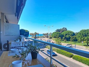 A balcony with a view of a road, greenery, and a clear sky. - L'Auteuil by Interhome (Cagnes-sur-Mer)
