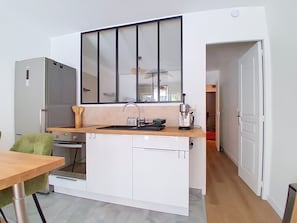 A compact kitchen with a built-in oven, a sink, and a window above the counter. - Le Tiercé by Interhome (Cagnes-sur-Mer)