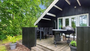 A deck with a grill, chairs, and a table. - "Maini" - 30km from the sea by Interhome (Toftlund)