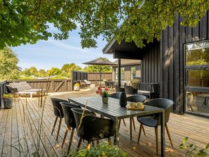 An outdoor patio with a dining table, chairs, and a barbecue area. - "Ozrenka" -  from the sea by Interhome (Hals)