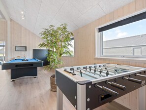 A room with a foosball table, a pool table, and a large window. - 5 Star Holiday Home in Romo (Rømø)
