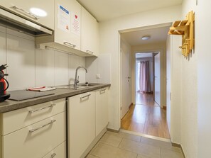 A compact kitchen with a sink, cabinets, and a countertop. - Haus Astoria Appartement/Fewo Apt. #7 by Interhome (Saas-Grund)