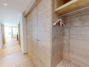 A modern interior with wooden flooring, a hallway leading to a room with a large wardrobe and a hanging garment rack. - Alphubel Peak & Unlimited Appartement/Fewo Peak 01 by Interhome (Saas-Fee)
