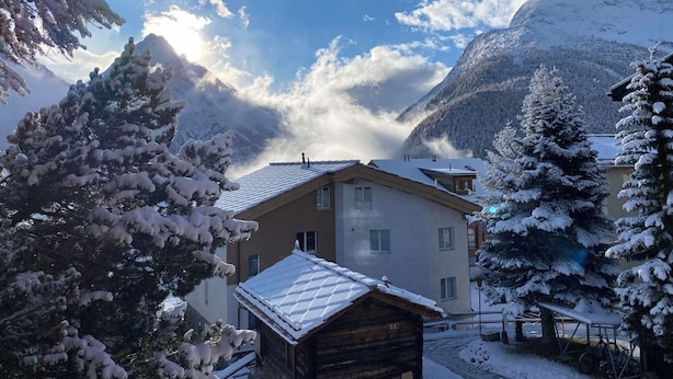 A mountain cabin with a snow-covered roof, surrounded by snow-laden trees and a mountain backdrop. - Sonnenhang 2 Appartement/Fewo Apartment Nr. 2 by Interhome (Saas-Fee)