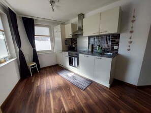 A compact kitchen with a built-in oven, a stovetop, and a sink. - Alpin Relax Appartement/Fewo Appartement/Fewo by Interhome (Saas-Almagell)