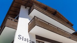 A multi-story building with a prominent 'Slalom' sign on the side. - Haus Slalom Appartement/Fewo Apt #1 by Interhome (Saas-Fee)