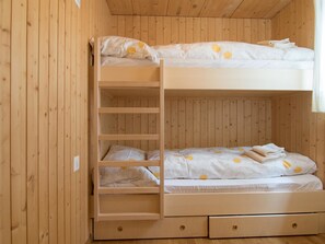 A bunk bed with a ladder, two drawers, and a window with curtains. - Chalet Renu Appartement/Fewo 6-Bettwohnung by Interhome (Saas-Fee)