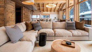 A modern interior with a large L-shaped sofa, wooden beams, and large windows. - Berghof Penthouse Appartement/Fewo 8-Bettwohnung by Interhome (Saas-Fee)