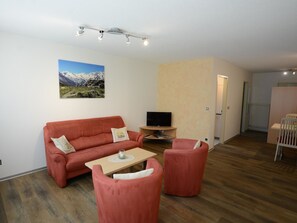A living room with a sofa, a coffee table, and a TV stand. - Kandahar Appartement/Fewo 4-Bettwohnung Nr. 2 by Interhome (Saas-Fee)