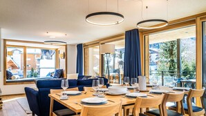 A modern dining area with wooden furniture, large windows, and a view of the outside. - Riverside 24 Appartement/Fewo Appartement/Fewo by Interhome (Saas-Fee)