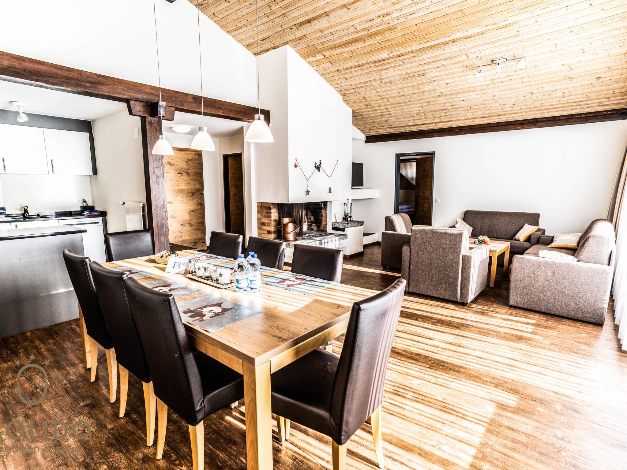 A modern interior with a dining area, kitchen, and living space.