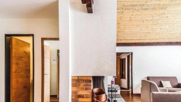 Ein modernes Wohnzimmer mit Kamin, einer Couch und einem Couchtisch.