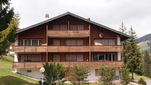 A multi-story wooden building with balconies, surrounded by greenery and a clear sky. - Zurbuchen Adolf & Erika Appartement/Fewo 4-Bettwohnung by Interhome (Habkern)