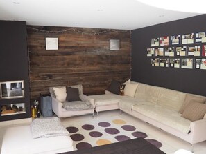 Ein modernes Wohnzimmer mit einem Ecksofa, einem Zweisitzer und einem Couchtisch.
