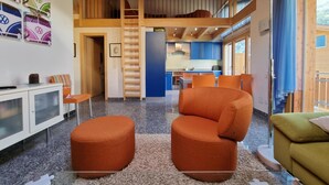 A modern interior with a loft bedroom, a kitchen, and a dining area. - Snow-Fun B Penthouse Appartement/Fewo Appartement/Fewo by Interhome (Saas-Fee)