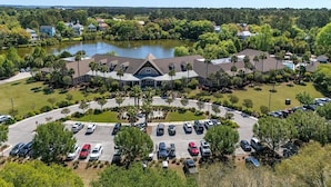 An aerial view of a hotel with a central building, a parking lot, and a lake in the background. - Cozy 1-bedroom condo in private Seabrook Island with 2 queen beds. (Seabrook Island)