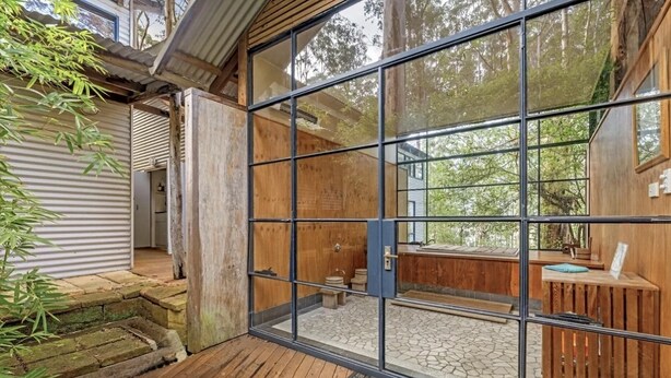 A wooden cabin with a glass door leading to a stone-tiled patio. - Inglenook: Cosy forest escape, 5min to Denmark (Denmark)