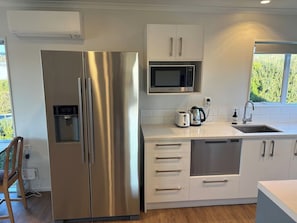 Fridge, microwave, oven, dishwasher - Spacious Waimārama Beach House with Large Deck (Waimārama)