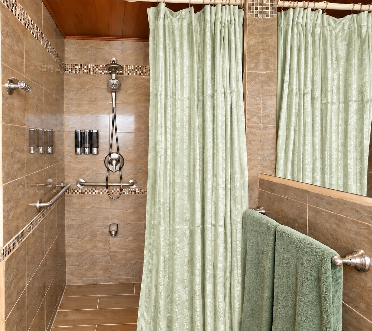 A bathroom with a shower, a towel rack, and a mirror.