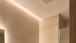 A modern bathroom with a toilet, sink, and shower.