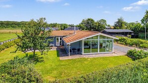 A modern house with a glass conservatory, surrounded by a well-maintained lawn and trees. - "Aderice" - 80m from the sea by Interhome (Haderslev)