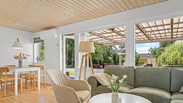 A modern living room with a sofa, a round table, a dining table with chairs, and a lamp. - "Gertraud" - 600m from the sea by Interhome (Væggerløse)