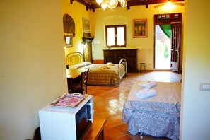 A bedroom with a bed, a desk, a chair, a radiator, and a door leading outside. - Vacation Home in Castelfiorentino with 1 bedrooms sleeps 4 (Castelfiorentino)