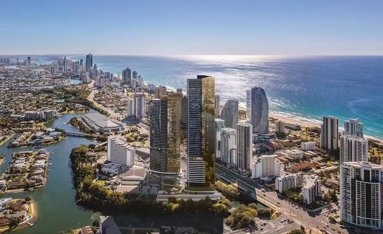 Un paisaje urbano costero con rascacielos, un río y una playa.