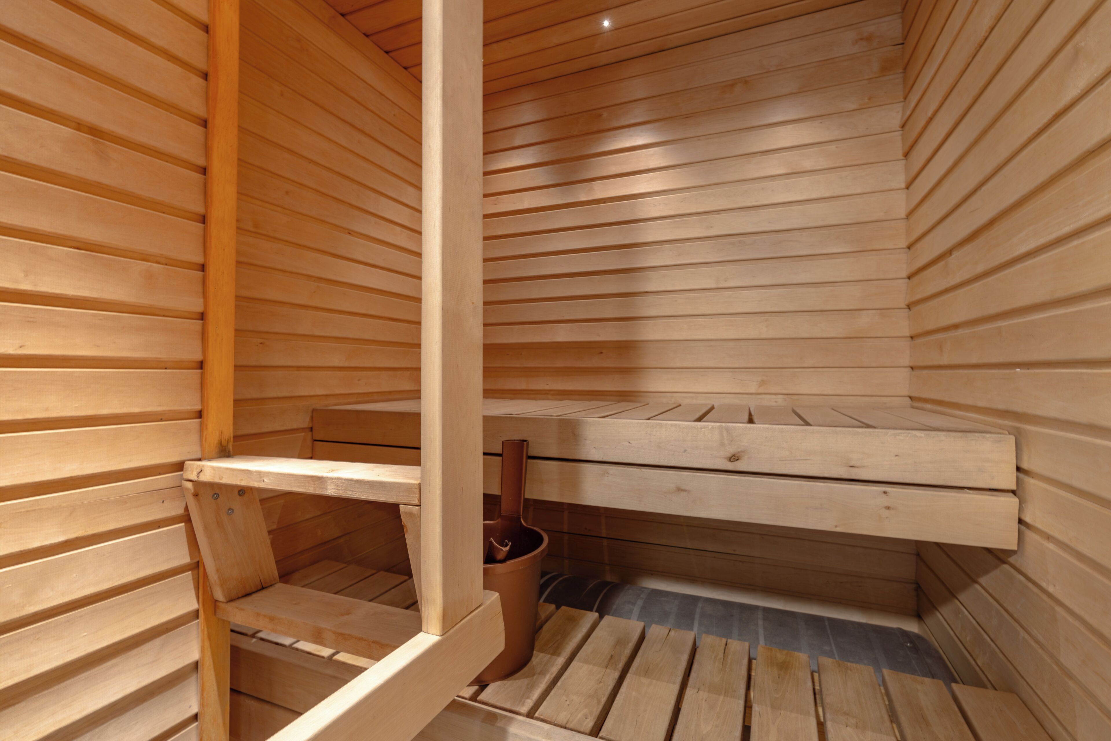 A sauna with wooden walls and benches.