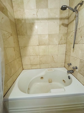 Jetted bath, towels, soap, toilet paper - Urban Industrial Loft - Exposed Brick, Skyline Views & Jetted Tub (Houston)