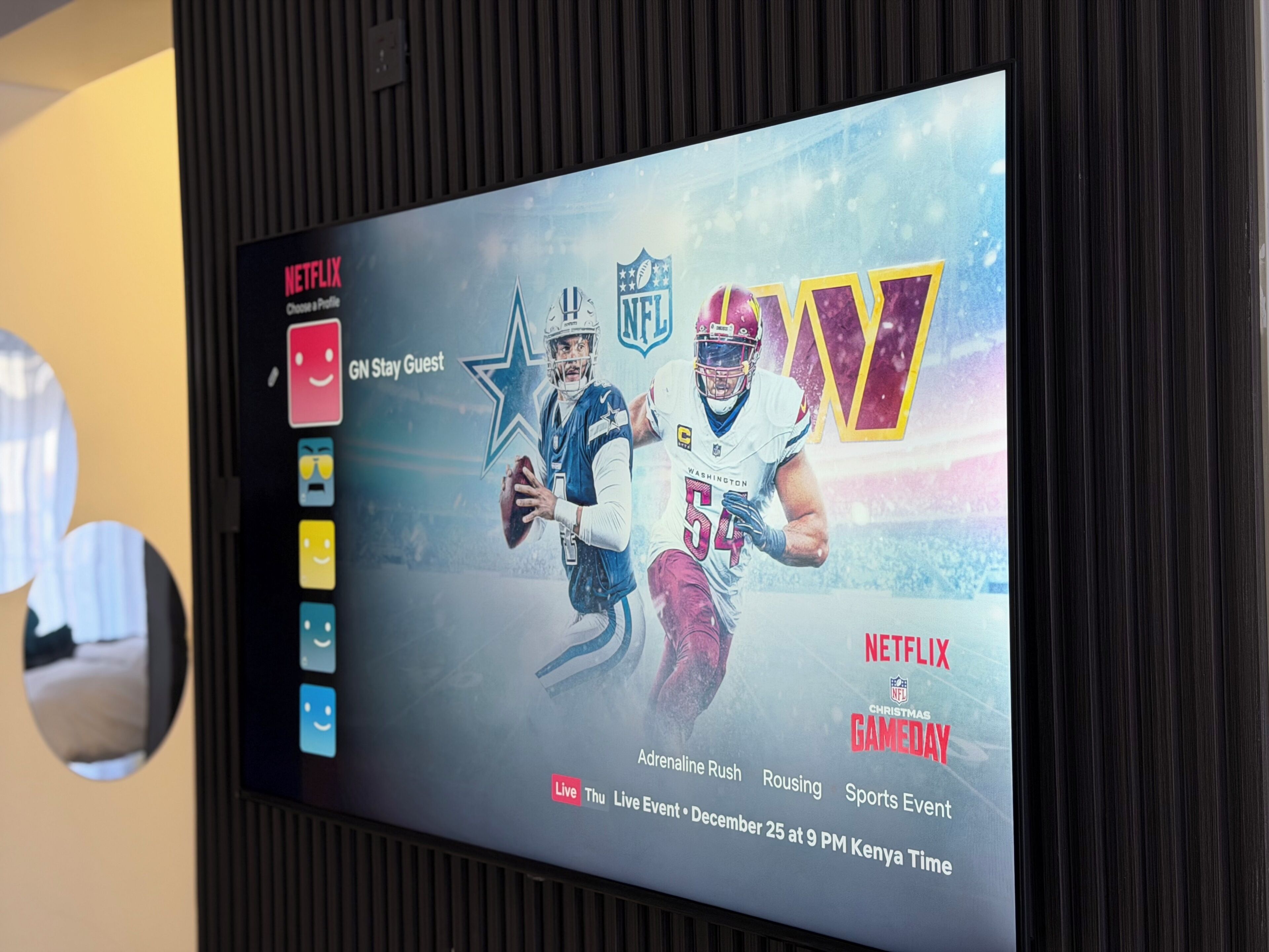 A television screen displaying a sports event with logos of NFL teams and a Netflix advertisement.